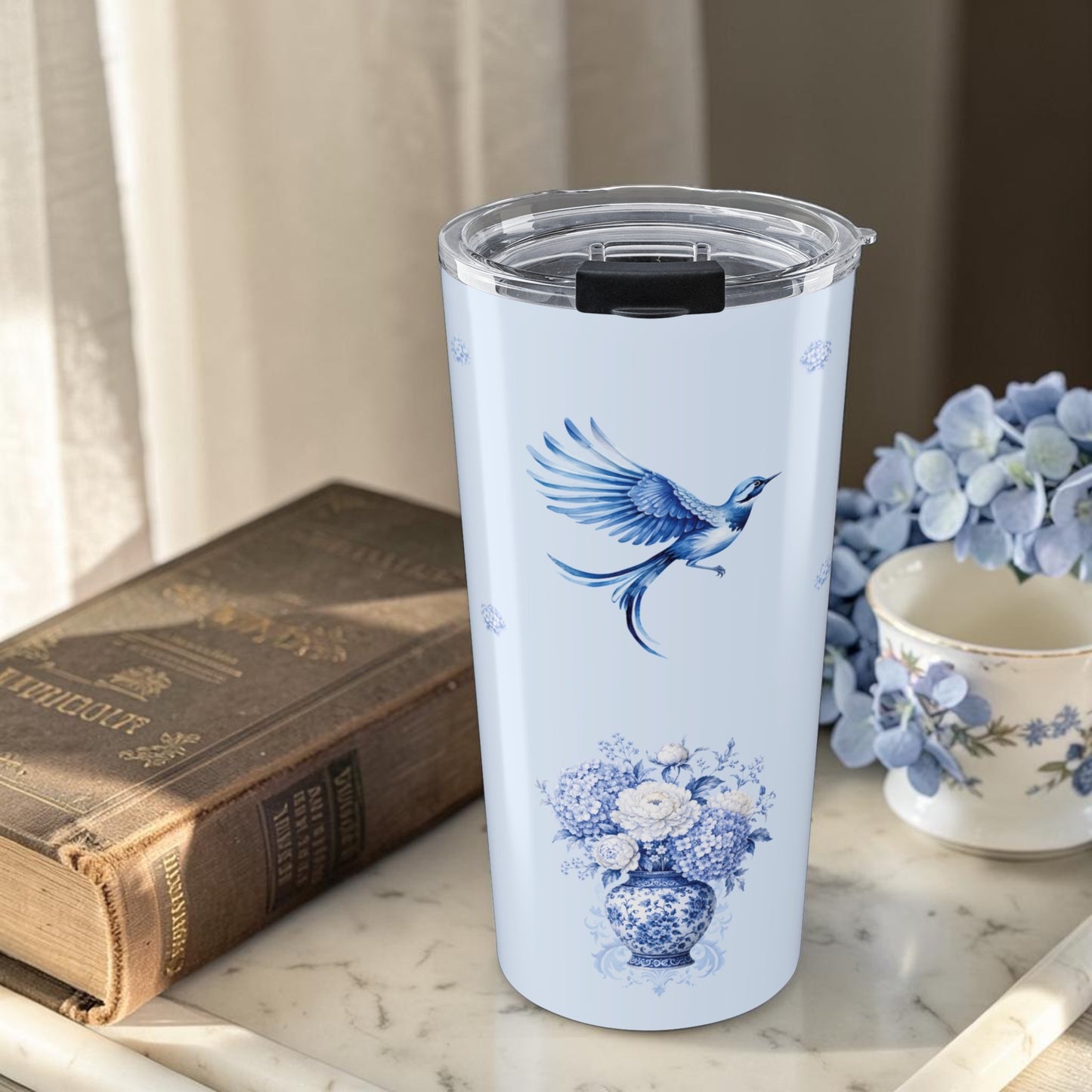 Blue porcelain vase tumbler styled with hydrangea flowers and elegant tea-time decor