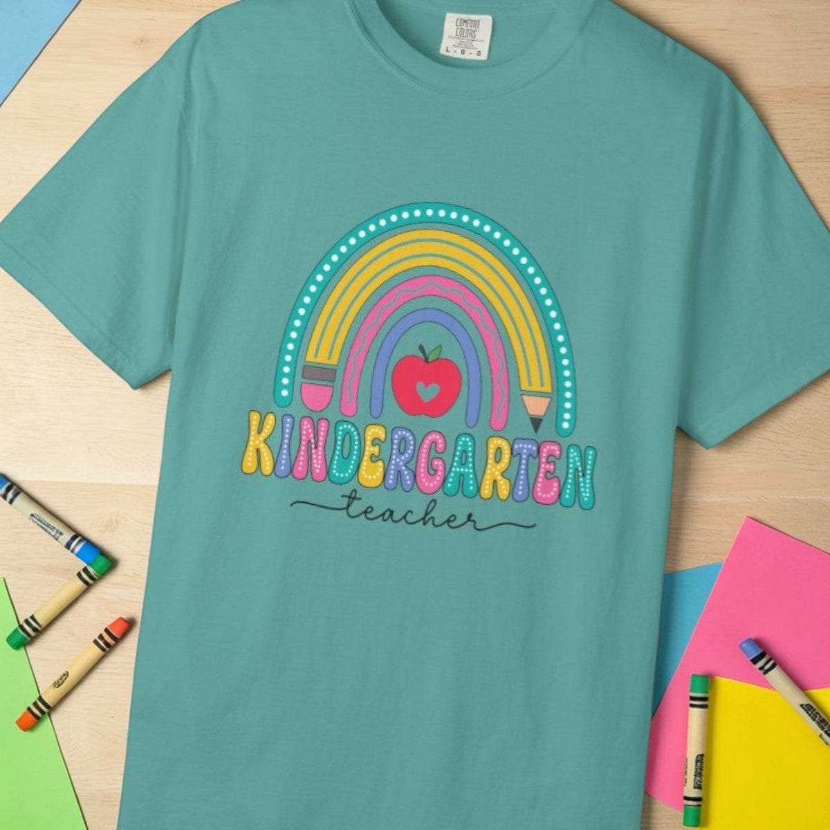 Seafoam t-shirt with rainbow, pencil and apple design, labeled 'Kindergarten teacher' ideal gift for teacher appreciation
