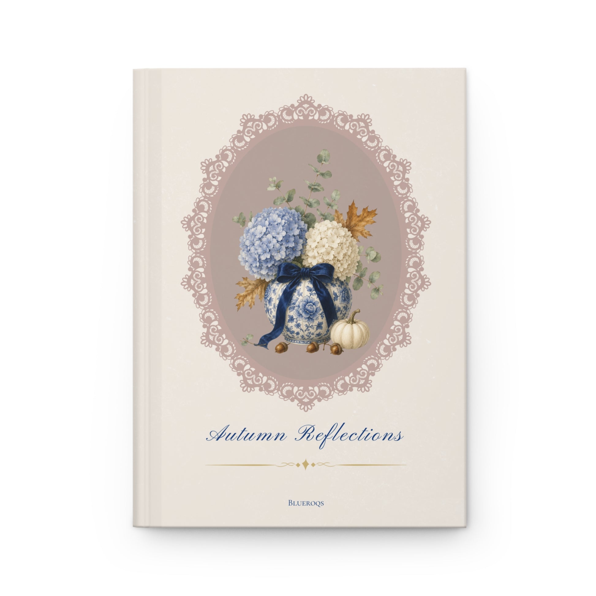 Autumn Reflections hardcover journal featuring blue and ivory hydrangeas in a porcelain vase with an ivory pumpkin inside an elegant heirloom cameo frame on a cream cover.