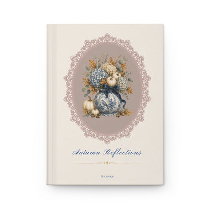 Autumn Reflections hardcover journal featuring a vintage floral arrangement of blue hydrangeas, porcelain-inspired vase, pumpkins and an elegant heirloom cameo frame on a cream cover.