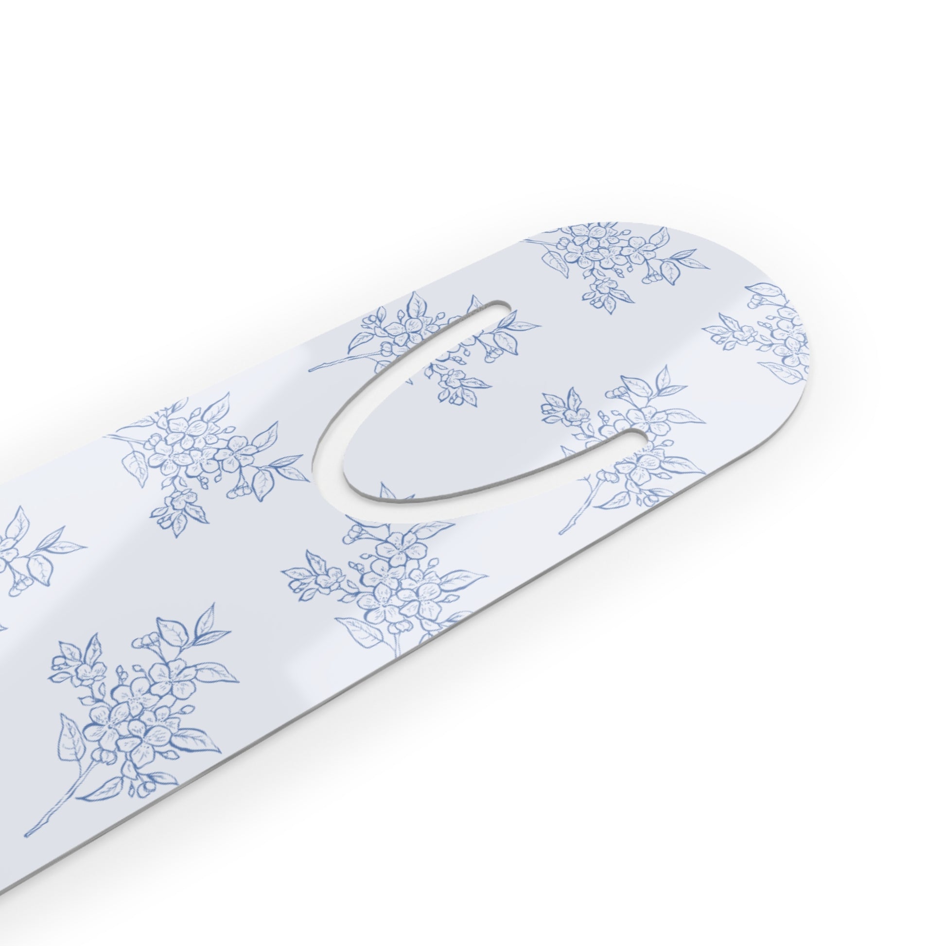 Close-up of a blue botanical metal bookmark featuring a vintage-inspired floral design