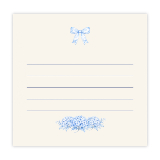 Blue bow and hydrangea sticky notes with lined writing space on an ivory note pad