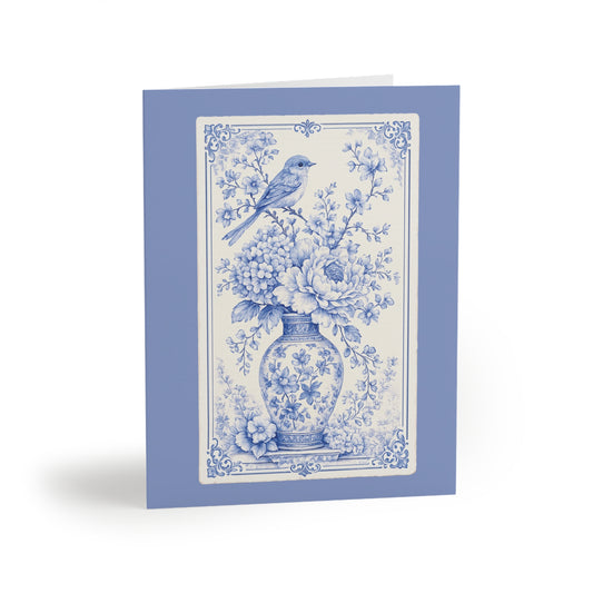 Blue chinoiserie floral greeting card featuring a vintage porcelain vase, blooming flowers, and a delicate bird illustration.