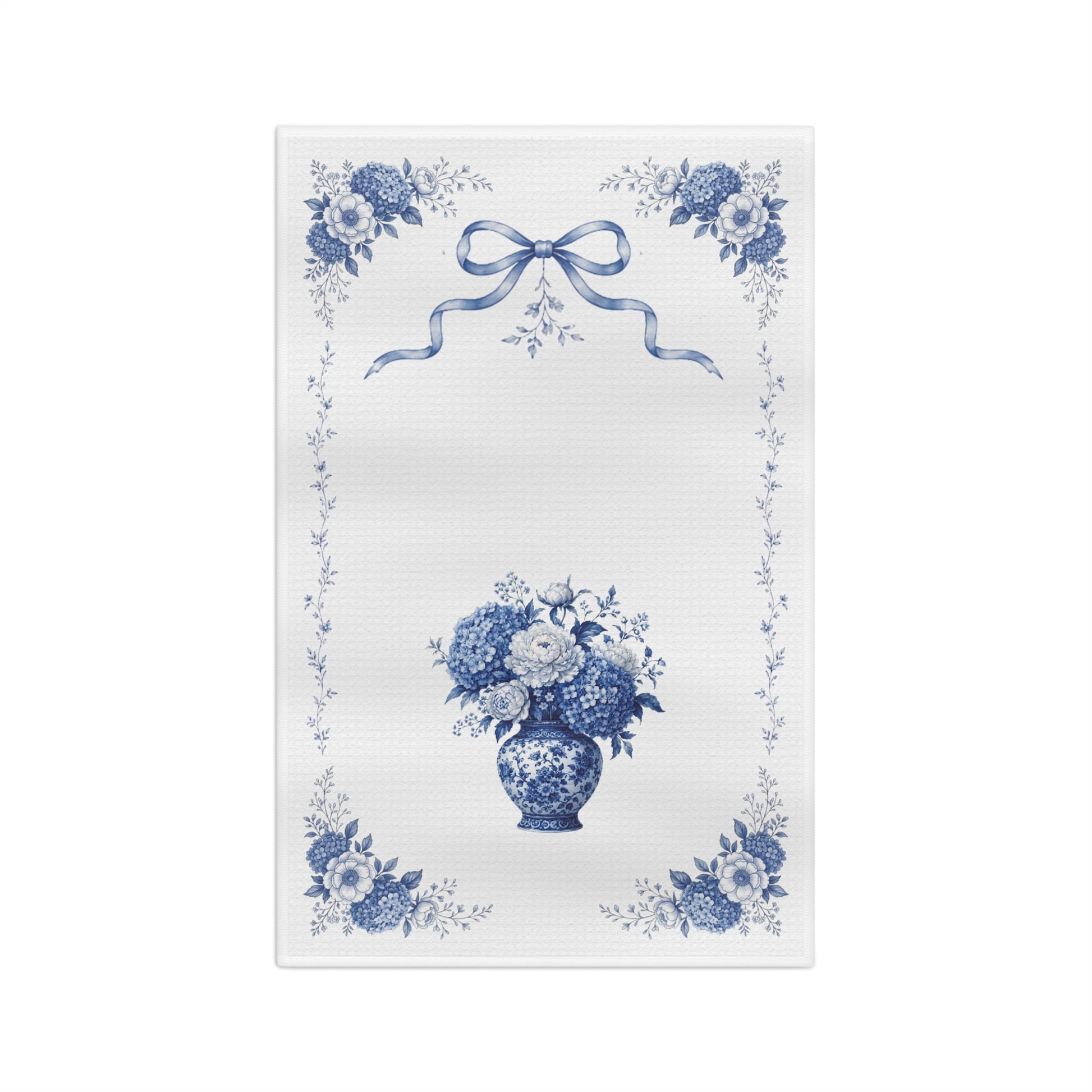 Front view of a blue Delft hydrangea microfiber tea towel with floral corners, ribbon detail, and a porcelain vase bouquet.