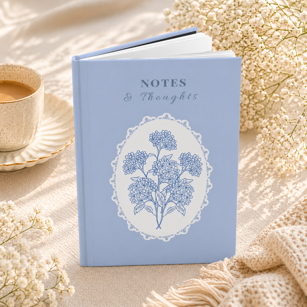 Hardcover blue floral lace notebook angled view showing thickness and matte finish, lined journal for everyday writing