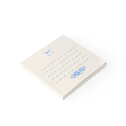 Blue bow floral sticky note pad shown in angled view with lined pages and hydrangea artwork