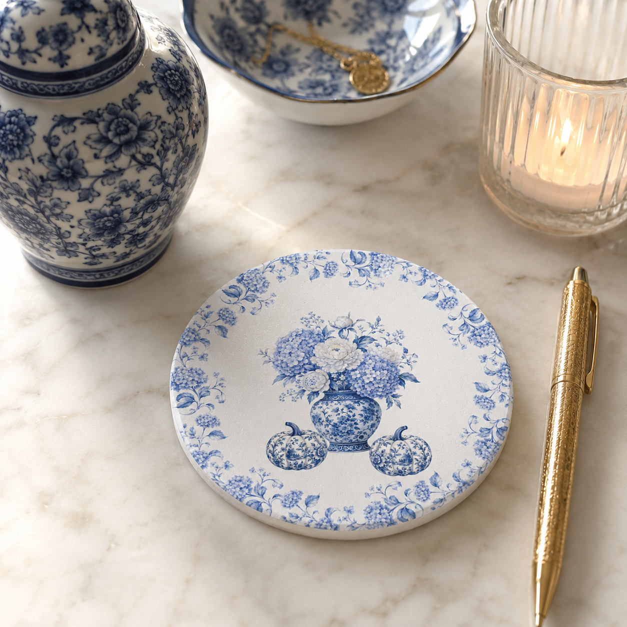 Blue floral ceramic coaster styled with a porcelain teacup and blue and white vase on a cozy tea table.