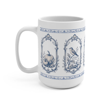 Right-side view of a vintage blue transferware ceramic mug with floral vase, pumpkin and bird illustrations in ornate frames.
