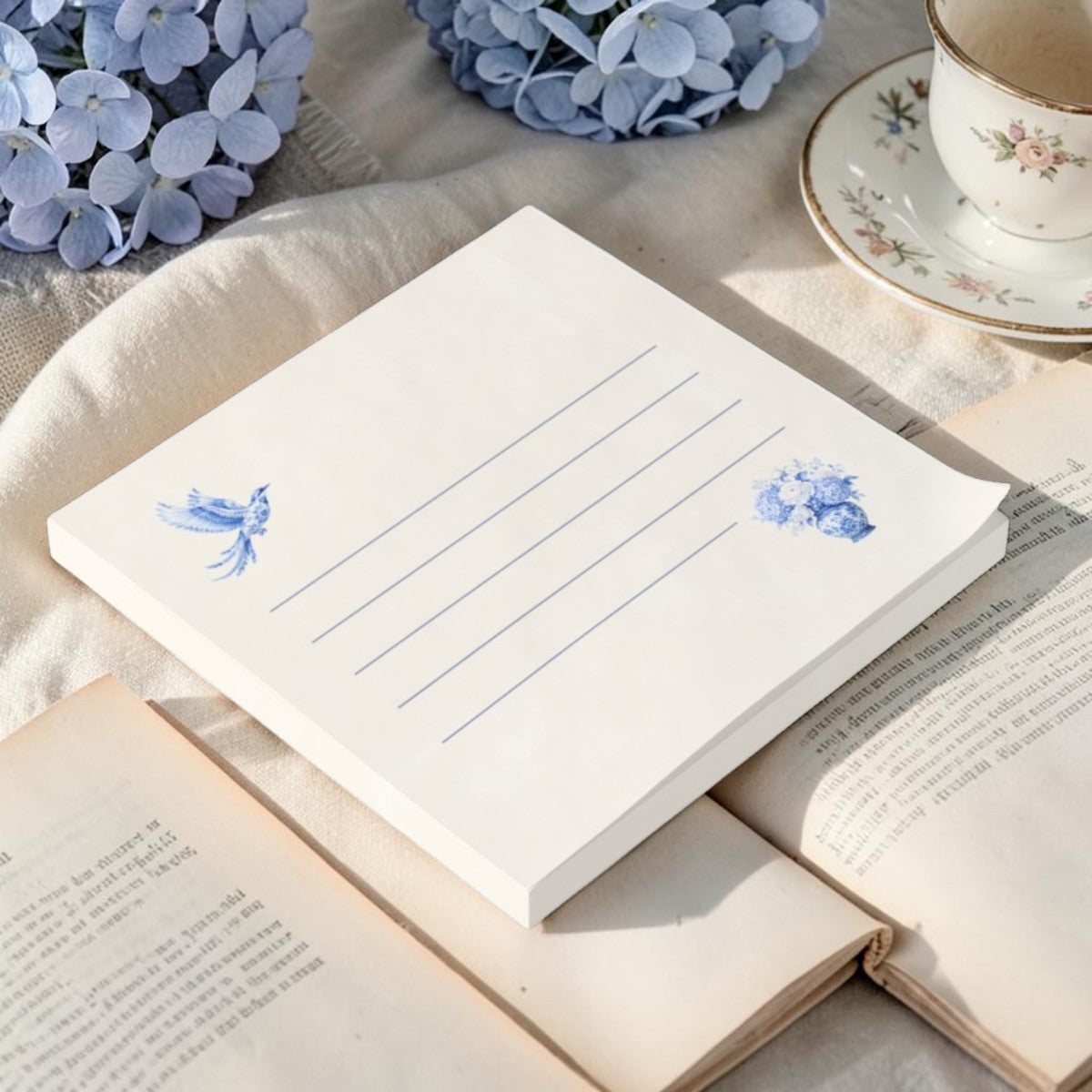 Blue chinoiserie bird sticky notes styled with books and hydrangeas for readers and stationery lovers