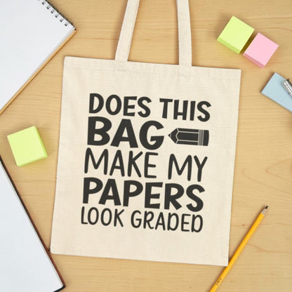 Beige teacher tote bag with text Does This Bag Make My Papers Look Graded