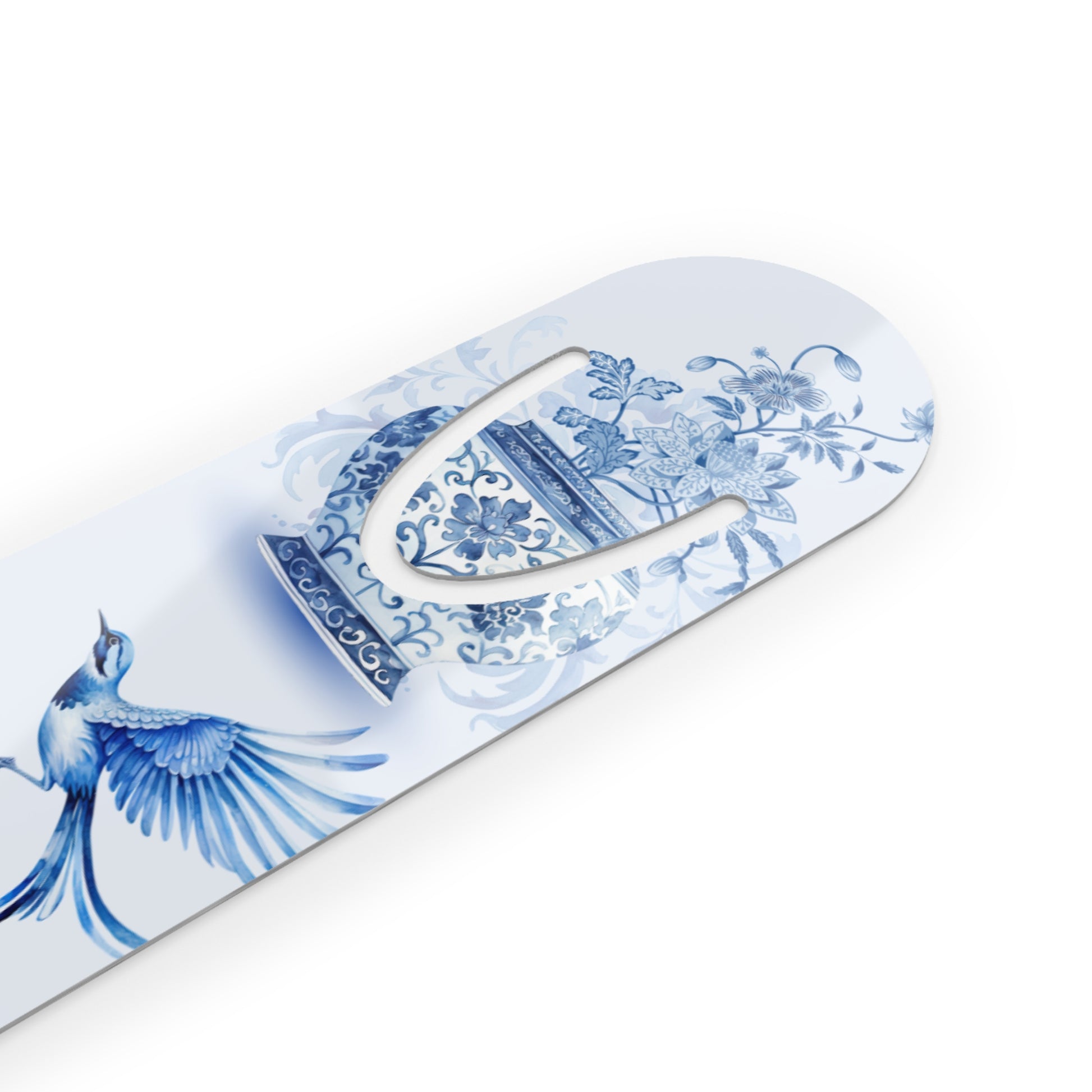 Close-up of a blue and white porcelain-inspired bird bookmark with floral vase artwork