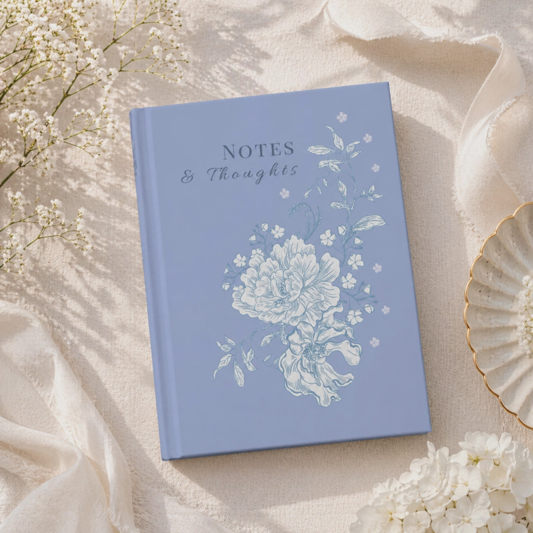 Blue floral hardcover journal with 'Notes & Thoughts' text, featuring white peony illustration on matte cover, aesthetic writing notebook for journaling and gifts