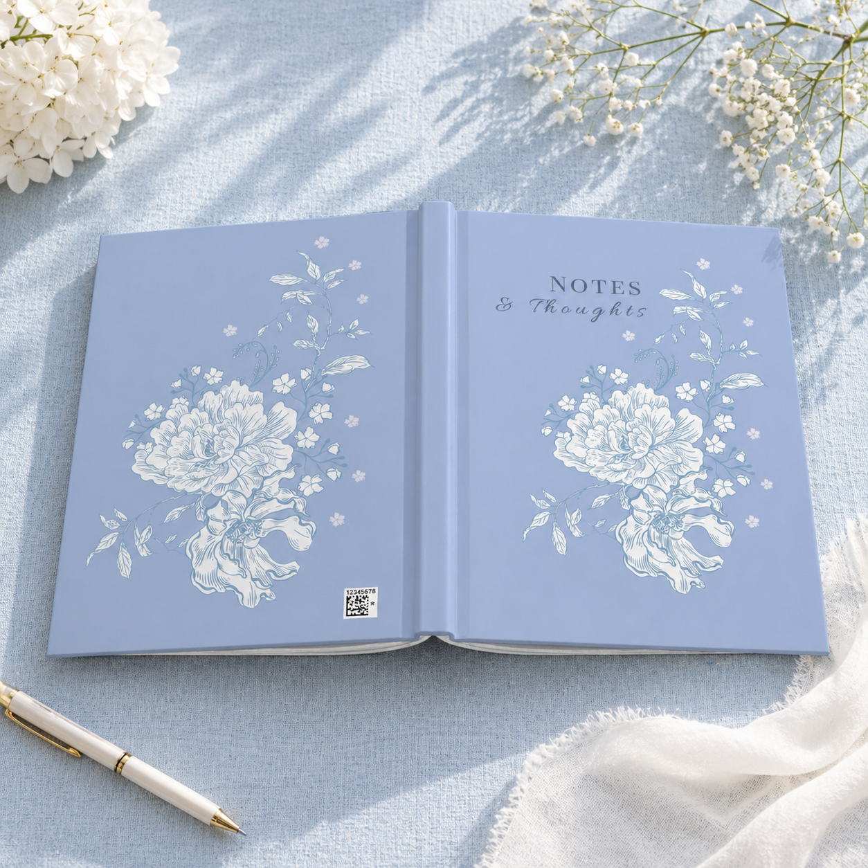Blue floral hardcover journal with 'Notes & Thoughts' text, featuring white peony illustration on matte cover, aesthetic writing notebook for journaling and gifts