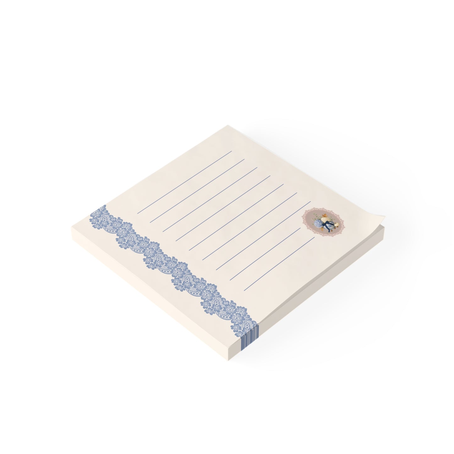 Angled view of the vintage floral sticky note pad featuring blue lace trim, lined writing pages, and a small botanical bouquet illustration.