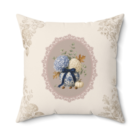Vintage floral throw pillow featuring a hydrangea bouquet in a porcelain vase with a navy ribbon, framed by an elegant lace-inspired medallion.